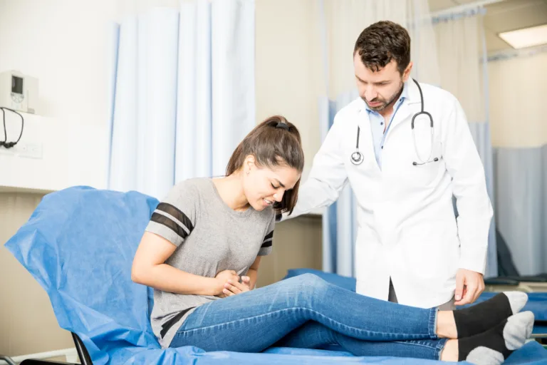 Woman with stomach ache visiting doctor